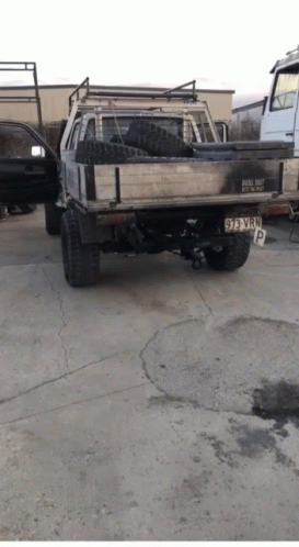 A Truck With A License Plate That Says 93 Vwp Is Parked In A Parking Lot GIF