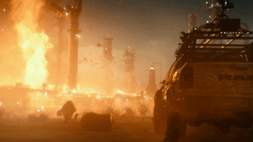 A Truck With The Word Raptor On The Back Is Parked In Front Of A Fire GIF