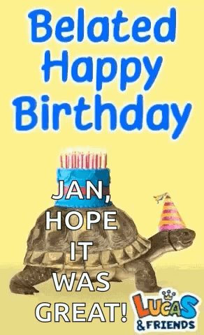 A Turtle Wearing A Party Hat Is Sitting On Top Of A Cake . GIF