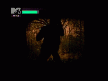 A Tv Screen Shows A Silhouette Of A Person In A Forest And Says Vma 2013 Agora At The Top GIF
