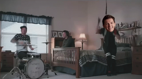 A Twenty One Pilots Drum Set Sits In A Bedroom Next To A Bed GIF