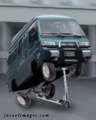A Van Is Sitting On Top Of A Scooter With Jucoolimages.com Written On The Bottom GIF