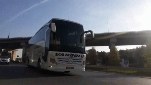 A Vanyolu Bus Is Driving Down A Highway Under A Bridge GIF