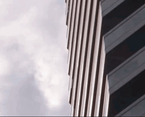 a very tall building with a cloudy sky behind it