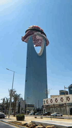 A Very Tall Building With A Scarf On Top GIF