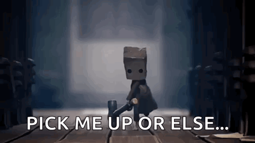 A Video Game Character With A Bag On His Head Is Standing On A Wooden Floor And Says `` Pick Me Up Or Else ... '' GIF