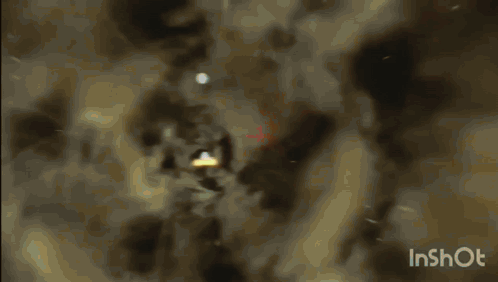 A Video Of A Light Coming Out Of A Hole In The Ground GIF