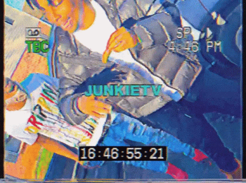 a video of a man reading a magazine says junkietv at the top