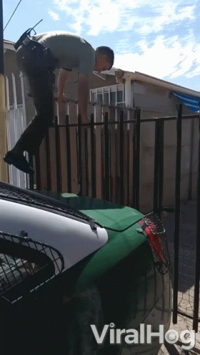 A Video Of A Police Officer Jumping Over A Fence Has The Word Viralhog On The Bottom GIF