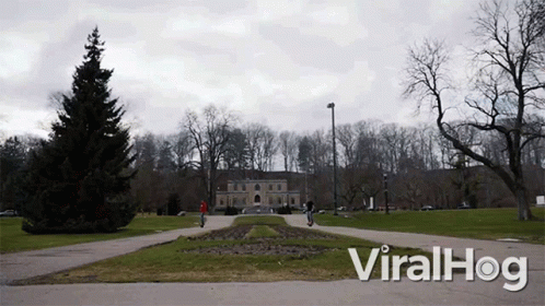 A Video Of People Riding Scooters In A Park With The Words Viralhog At The Bottom GIF