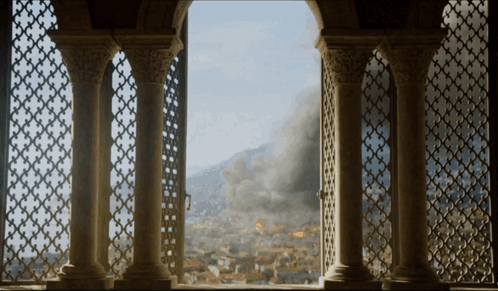 A View Of A City From A Balcony With Columns GIF