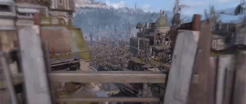 A View Of A City From Behind A Wooden Fence With A Mountain In The Background . GIF