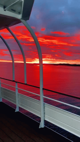 A View Of A Sunset From A Boat Deck GIF