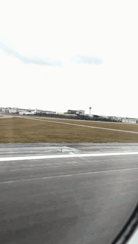 A View Of An Airport Runway From An Airplane GIF