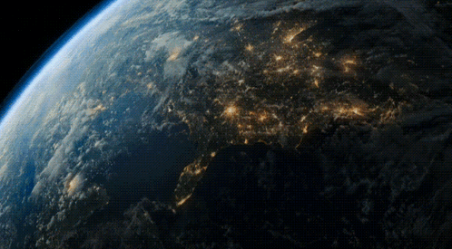 A View Of The Earth From Space At Night With A Lot Of Lights Visible GIF