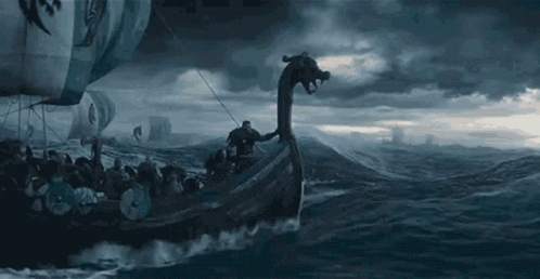 A Viking Ship With A Dragon Head Is Floating On Top Of A Body Of Water . GIF