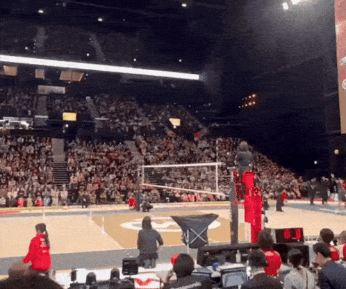 A Volleyball Game Is Being Played In A Stadium With A Large Crowd GIF