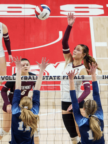 A Volleyball Game Is Being Played In Front Of A Banner That Says State Finals GIF