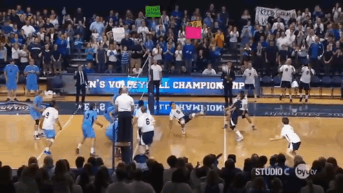 A Volleyball Game Is Being Played In Front Of A Crowd With A Banner That Says ' Men 'S Volleyball ' GIF