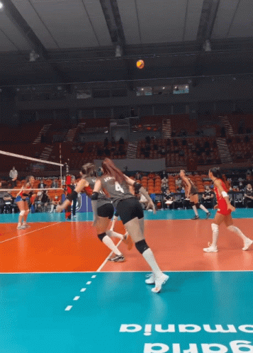 A Volleyball Game Is Being Played On A Court That Says ' Smania ' On The Floor GIF