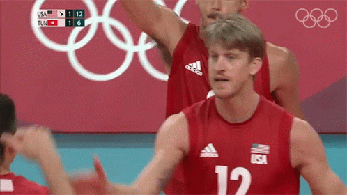 A Volleyball Player Wearing A Red Jersey With The Number 12 On It GIF