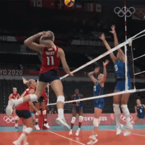 a volleyball player wearing number 11 jumps in the air