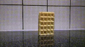 A Waffle Bar Is Sitting On A Counter In Front Of A Tiled Wall .. GIF