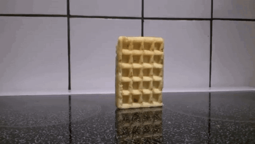A Waffle Sitting On Top Of A Black Counter GIF