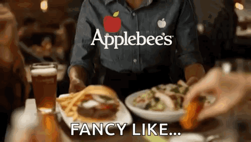 A Waitress At Applebee 'S Is Serving A Hamburger And French Fries GIF
