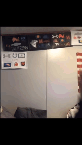 A Wall With A Bunch Of Under Armour Posters On It GIF
