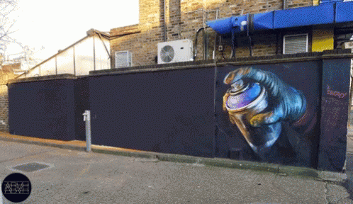 A Wall With A Painting Of A Hand Holding A Spray Can With The Word Energy Written On It GIF