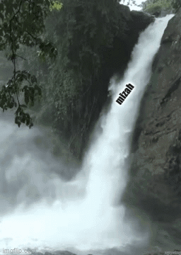 A Waterfall In The Woods With The Word Mitzah On It . GIF