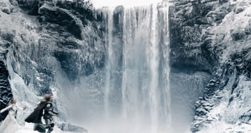 A Waterfall Is Surrounded By Ice And Snow GIF