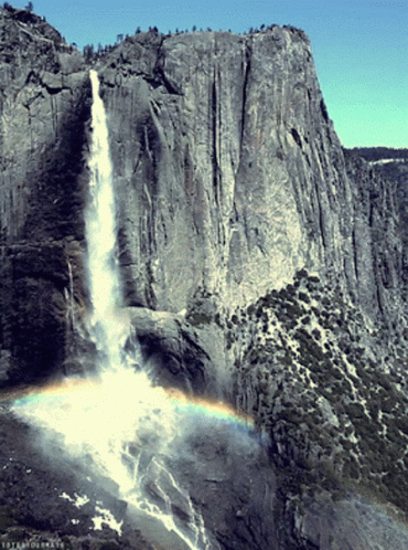 A Waterfall With A Rainbow In The Foreground And The Word Yosemite On The Bottom GIF