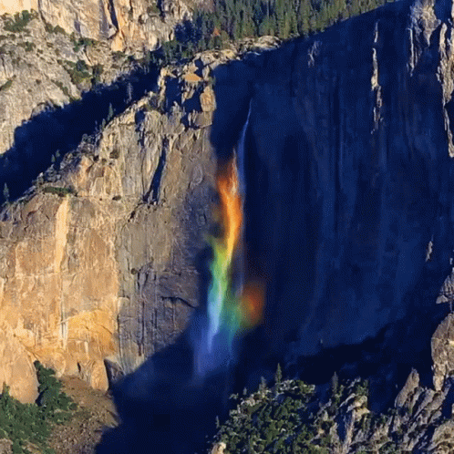 A Waterfall With A Rainbow In The Middle GIF