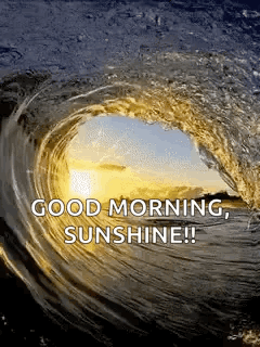 a wave in the ocean with the words `` good morning sunshine '' written on it .