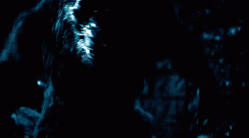 A Werewolf With Its Mouth Open In The Dark GIF
