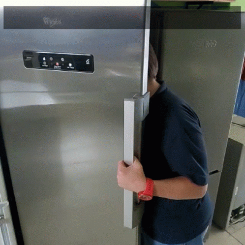 A Whirlpool Refrigerator Is Being Opened By A Man GIF