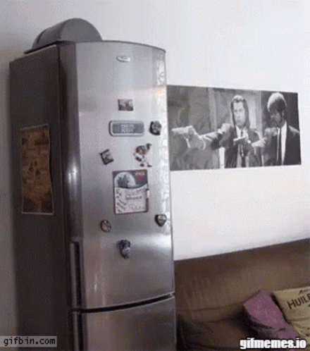 A Whirlpool Refrigerator With A Picture Of Pulp Fiction On The Wall GIF