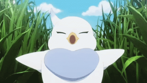 A White Bird With A Heart Shaped Mouth Is Standing In A Field Of Grass GIF