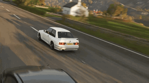 A White Bmw Is Driving Down A Road With A Yellow License Plate That Says ' Aoc ' On It GIF