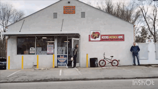 A White Building With A Red Sign That Says Food Patrol Etc GIF