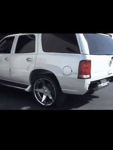 A White Cadillac With A License Plate That Says ' California ' GIF