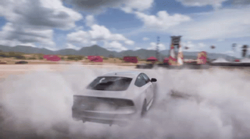A White Car Is Drifting On A Dirt Road With Smoke Coming Out Of It GIF