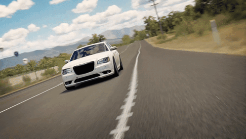 A White Car Is Driving Down A Country Road GIF
