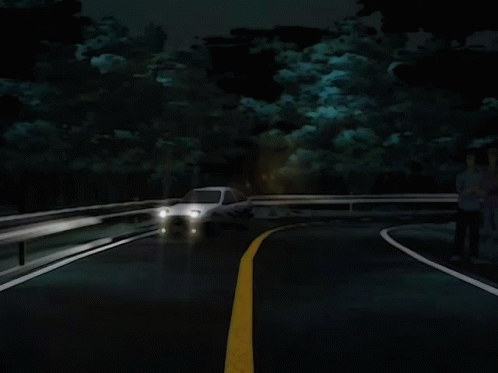 A White Car Is Driving Down A Dark Road GIF