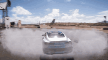 A White Car Is Driving Down A Dirt Road With Smoke Coming Out Of It GIF