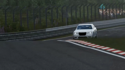 A White Car Is Driving Down A Race Track With A Red White And Blue Stripe On The Side GIF