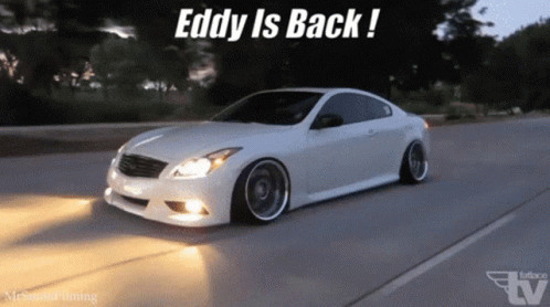 A White Car Is Driving Down A Road With The Words " Eddy Is Back " On The Bottom GIF