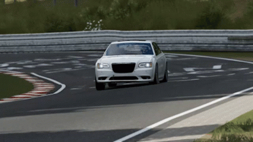 A White Car Is Driving On A Race Track GIF
